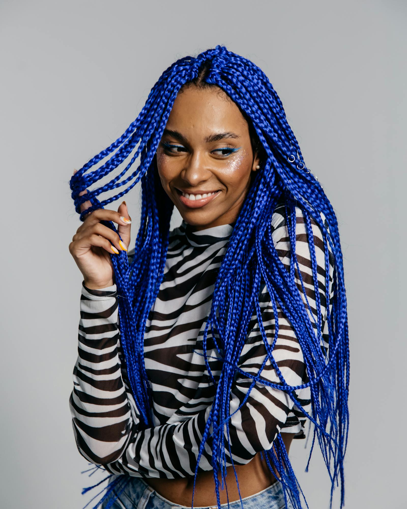 Long blue box braids styled in studio