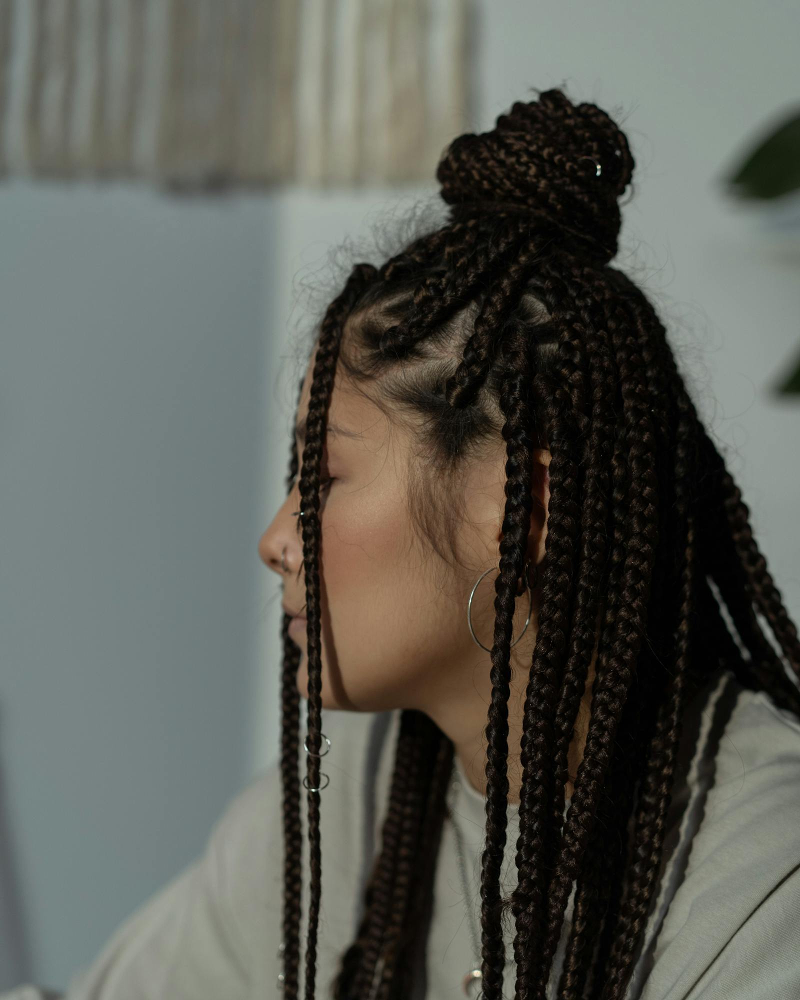 Brunette knotless braids in a half-up style